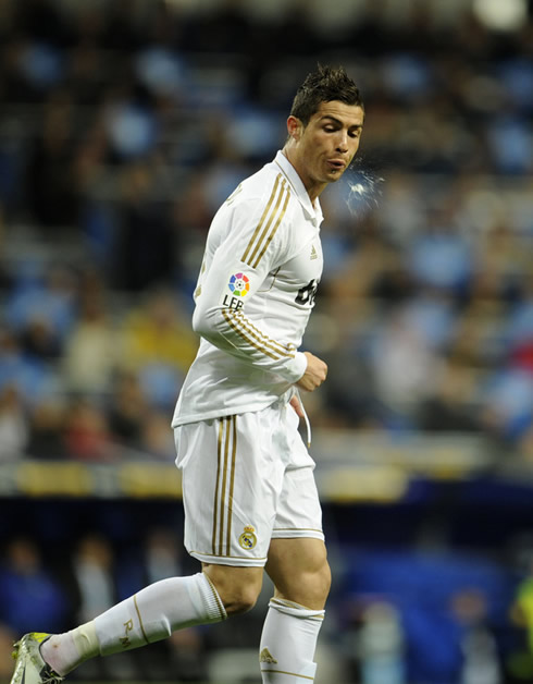 Cristiano Ronaldo spitting to his side in a Real Madrid game in 2012