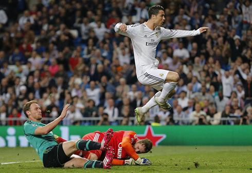 Cristiano Ronaldo jumping above two players in a Champions League match