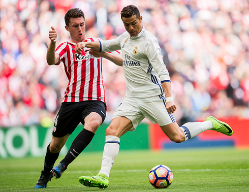 Cristiano Ronaldo tries to shoot with his left foot as a defender closes down on him
