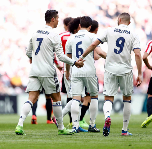 Cristiano Ronaldo holds hands with Benzema, as Real Madrid players return to their half of the pitch