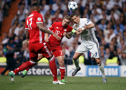 Cristiano Ronaldo and Philipp Lahm trying to head the ball at the same time