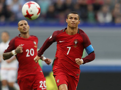 Cristiano Ronaldo chases the ball while Quaresma runs behind him