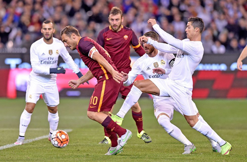 Cristiano Ronaldo tackling Francesco Totti, in Real Madrid vs AS Roma, at the Melbourne Cricket Ground