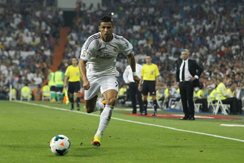 Cristiano Ronaldo running after the ball, with Carlo Ancelotti watching it from behind