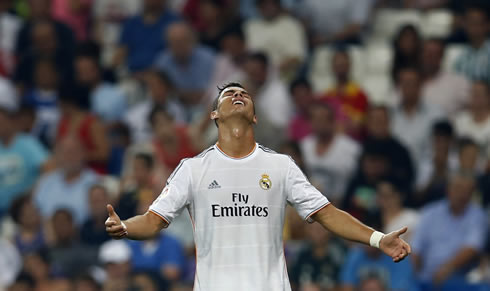 Cristiano Ronaldo sending his head back and opening the arms, in Real Madrid 2013