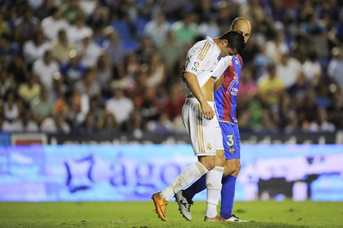 Cristiano Ronaldo hiding his face on his jersey after being elbowed by an opponent in La Liga 2011-12 against Levante