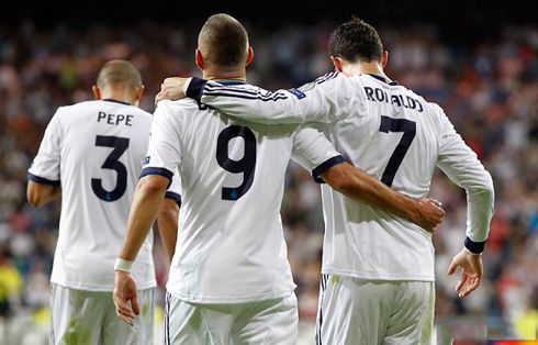 Cristiano Ronaldo putting his hand over Karim Benzema's back, as they both head back after Real Madrid pulled off the equalizer against Manchester City, in 2012-13