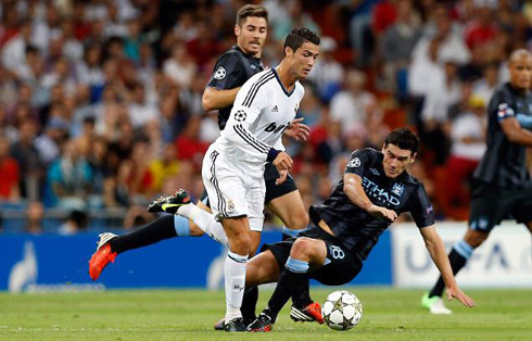 Cristiano Ronaldo leaving Gareth Barry and Javi Garcia behind him, in another run he made in Real Madrid vs Manchester City, in 2012-2013