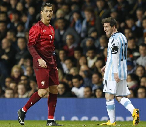 Cristiano Ronaldo standing near Lionel Messi, in Portugal vs Argentina at Old Trafford
