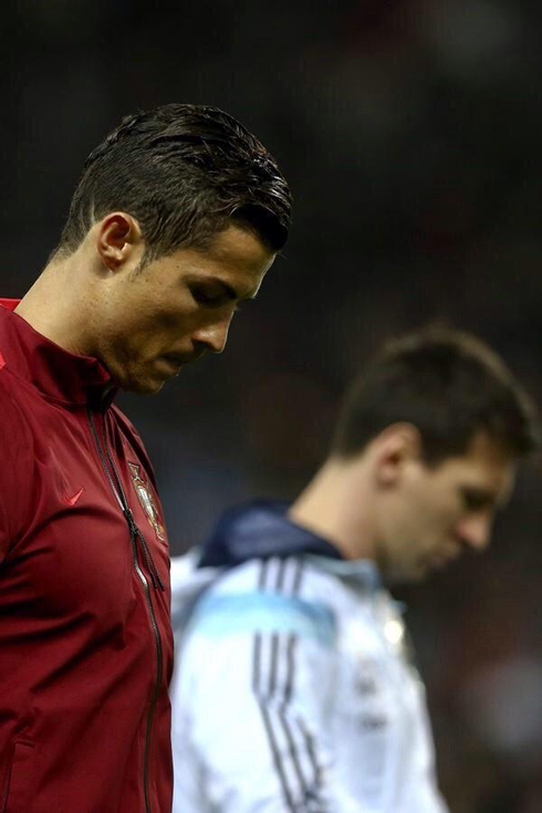 Cristiano Ronaldo and Lionel Messi both with their heads down before an international game for their countries