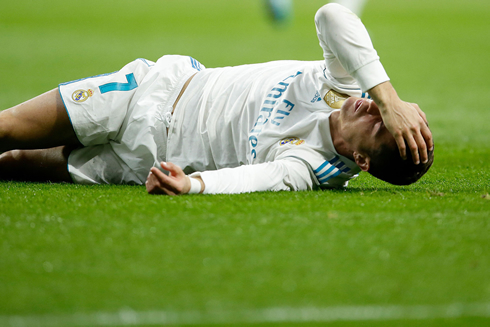 Cristiano Ronaldo goes to the ground and puts his hand on his forehead