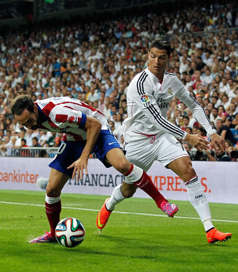Cristiano Ronaldo getting past an Atletico Madrid defender, in the Spanish Super Cup 2014