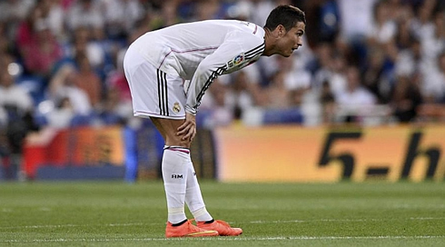 Cristiano Ronaldo bending over his knee, as he rests for a few seconds during the game
