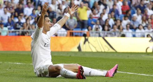 Cristiano Ronaldo goes to the ground and waves at the referee