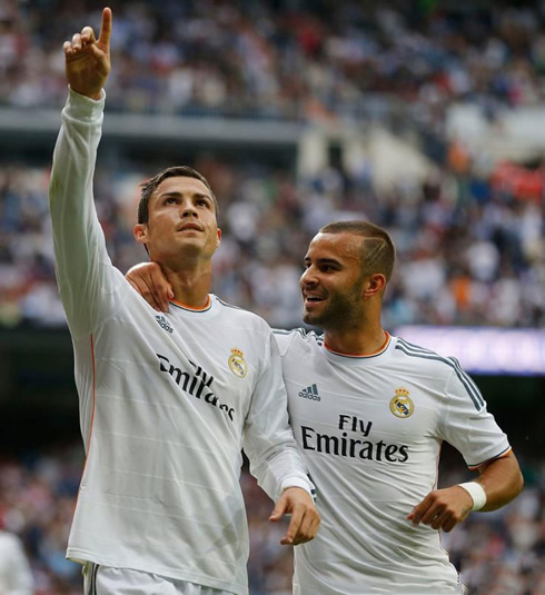 Cristiano Ronaldo pointing to his family members in the Bernabéu stands, with Jesé Rodriguez near him