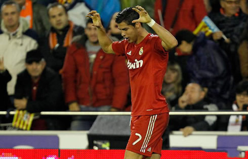 Cristiano Ronaldo doing the claw celebration during his goal celebrations in a Real Madrid red jersey/shirt 2011-2012