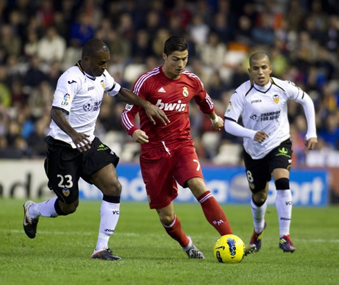 Cristiano Ronaldo running with the ball with Miguel attempting to steal it