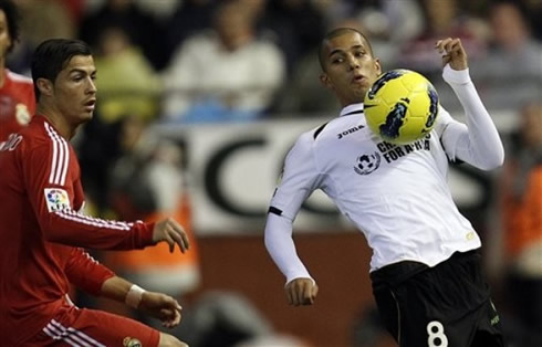 Cristiano Ronaldo defending against a Valencia player