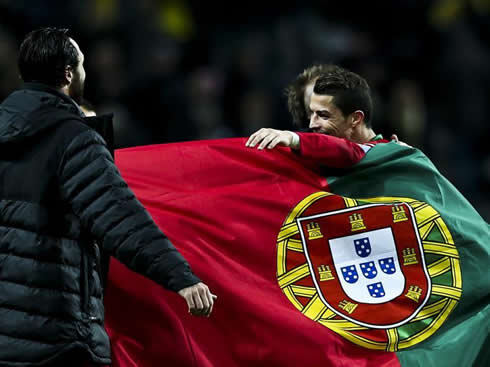 Cristiano Ronaldo wrapped up in a Portuguese flag
