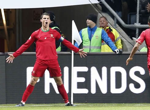 Cristiano Ronaldo opening his arms and legs as he waits to celebrates with his Portuguese teammates