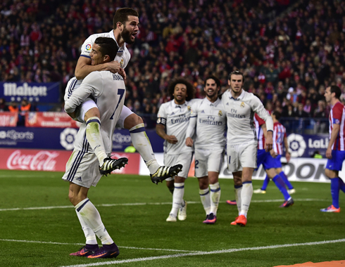 Cristiano Ronaldo picks Nacho on his lap, as they celebrate Real Madrid goal and victory over Atletico Madrid