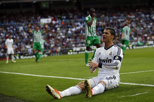 Cristiano Ronaldo sits on the pitch and looks at the fans in the crowd, in Real Madrid vs Betis, for La Liga 2013