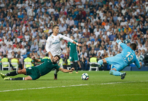 Cristiano ronaldo tries to get to a loose ball with two Betis players