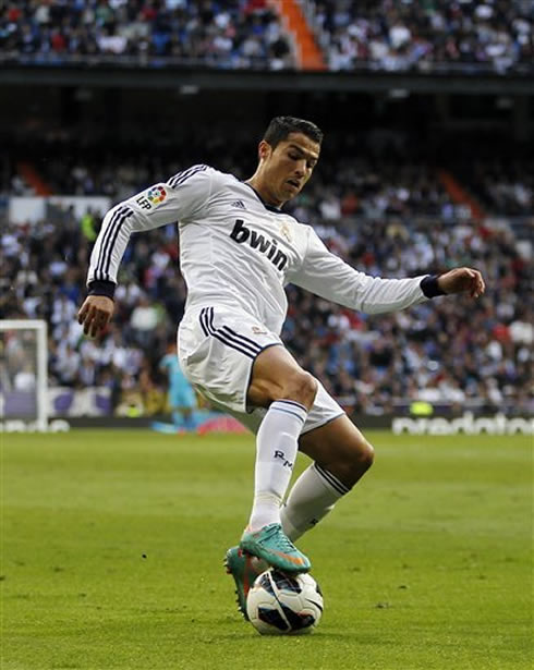 Cristiano Ronaldo controlling the ball with his right foot, during a Real Madrid game in 2012-2013
