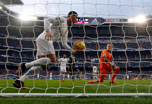 Cristiano Ronaldo picking up the ball after scoring in the back of the net