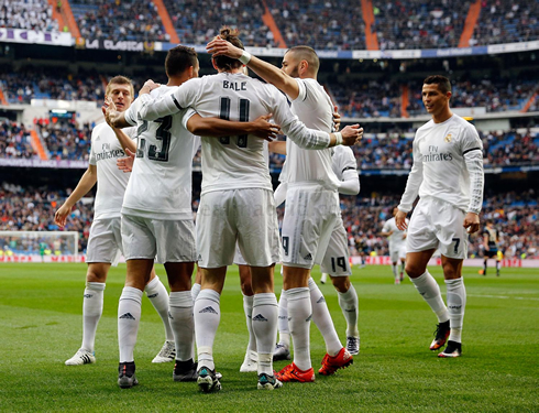 Cristiano Ronaldo approaching his teammates to celebrate a Real Madrid goal at the Bernabéu