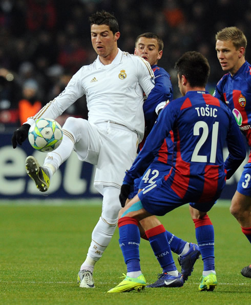 Cristiano Ronaldo holding the ball with his toes, while guarded by 3 CSKA defenders, including Tosic