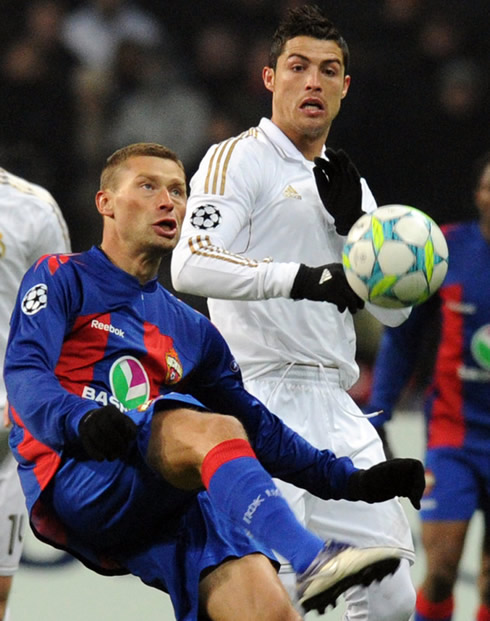 Cristiano Ronaldo looking closely at the ball, as he attempts to steal from a CSKA Moscow player