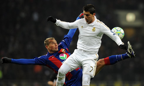 Cristiano Ronaldo jumps with a Russian defender when trying to win the ball for Real Madrid