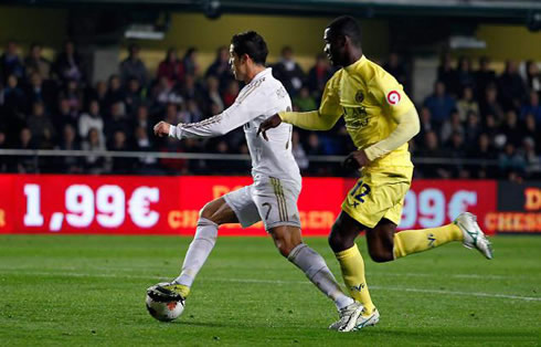 Cristiano Ronaldo protecting the ball from a defender and getting past him