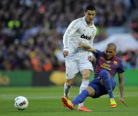 Cristiano Ronaldo being tackled by Daniel Alves, in Barcelona 1-2 Real Madrid