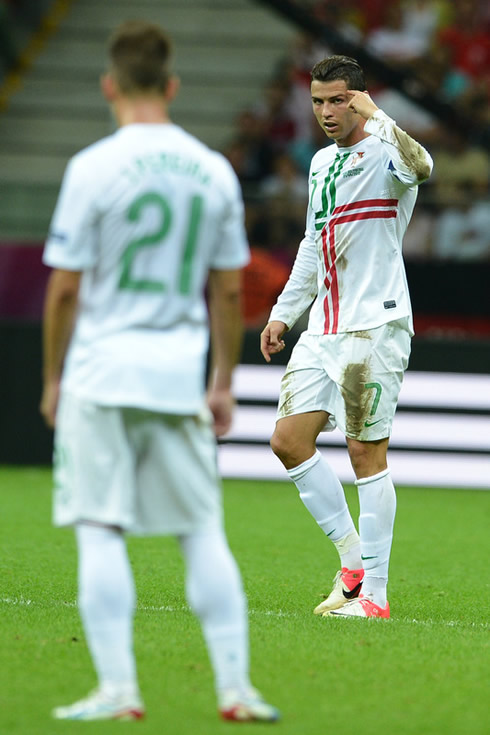 Cristiano Ronaldo playing his role of Portuguese captain and pointing to his head when recommending his teammates to be smart, at the EURO 2012