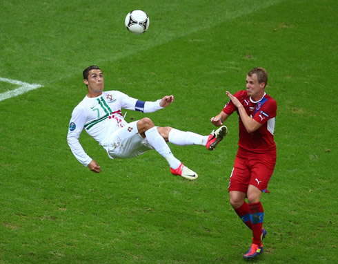 Cristiano Ronaldo in the air preparing to shoot from a bycicle kick attempt, in the EURO 2012