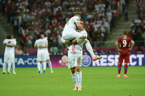 Cristiano Ronaldo holding Miguel Veloso on his lap, at the EURO 2012 quarter-finals post-match celebrations