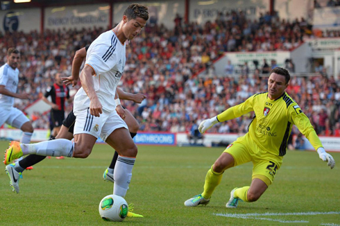 Cristiano Ronaldo getting around Bournemouth goalkeeper before scoring the second for Real Madrid, in a friendly during the club's pre-season in 2013