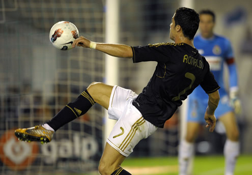 Cristiano Ronaldo reaching the ball in Racing Santander vs Real Madrid, La Liga match in 2011-2012