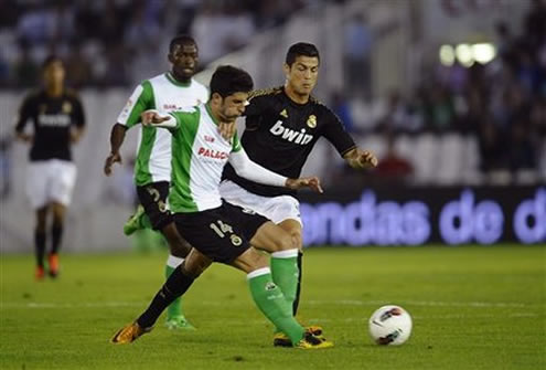 Cristiano Ronaldo defending and attempting to steal the ball in Racing Santander vs Real Madrid, La Liga match in 2011-2012