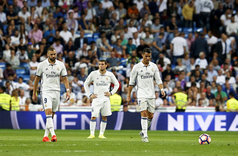 Real Madrid players with their heads down after conceding a goal