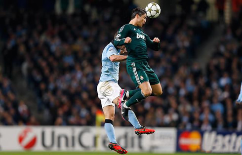 Cristiano Ronaldo jumping and heading the ball on its peak point in the air, in Manchester City vs Real Madrid in 2012-2013