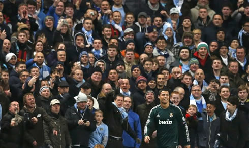 Cristiano Ronaldo smiling while Manchester City fans mock him and insult him, in a UEFA Champions League game involving Real Madrid in 2012-2013