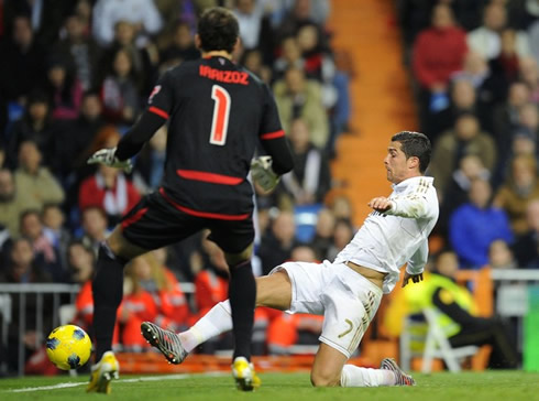 Cristiano Ronaldo stretching his right leg in an attempt to reach the ball before she cross the end line