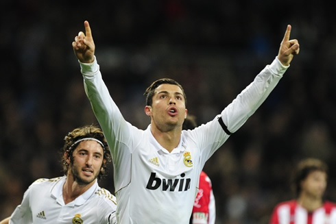 Cristiano Ronaldo raising his two arms after scoring a goal in Real Madrid vs Athletic Bilbao, with Granero pulling him from behind