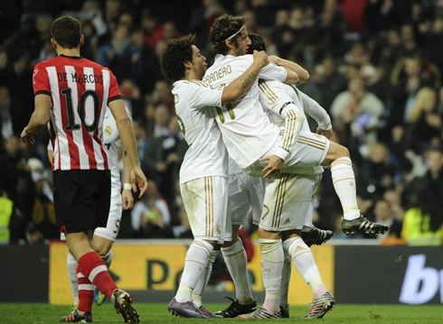 Esteban Granero fully mounted on Cristiano Ronaldo lap, while Marcelo holds them