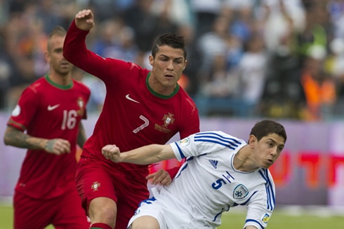 Cristiano Ronaldo fighting for the ball with a defender from Israel, in a FIFA World Cup 2014 qualifier game