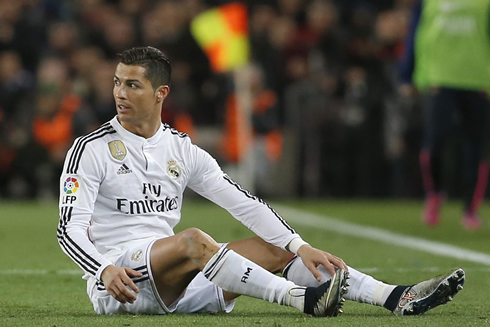 Cristiano Ronaldo seated on the turf at the Camp Nou
