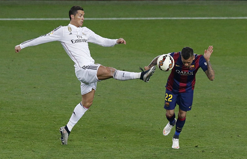 Cristiano Ronaldo showing his boot studs to Daniel Alves, in a loose ball